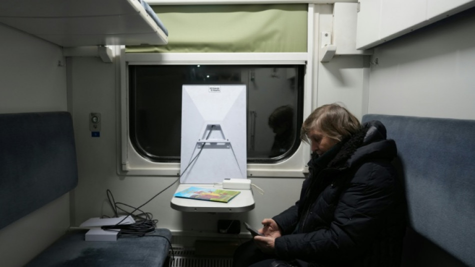 Freezing Kyiv residents seek warmth in trains and tents