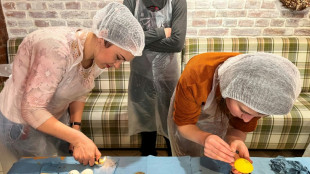 Displaced Ukrainians adorn Easter eggs for soldiers on the front