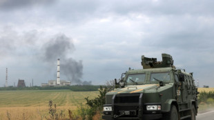Road shelled as Russian forces battle for devastated Ukraine city