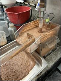 A machine with brown liquid in it AI-generated content may be incorrect.